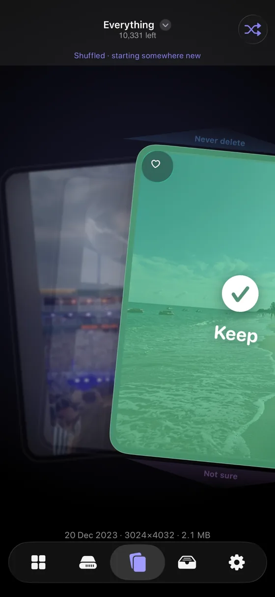 A photo being swiped right in Keep & Clear, tinted green and overlaid with a tick and the word Keep.