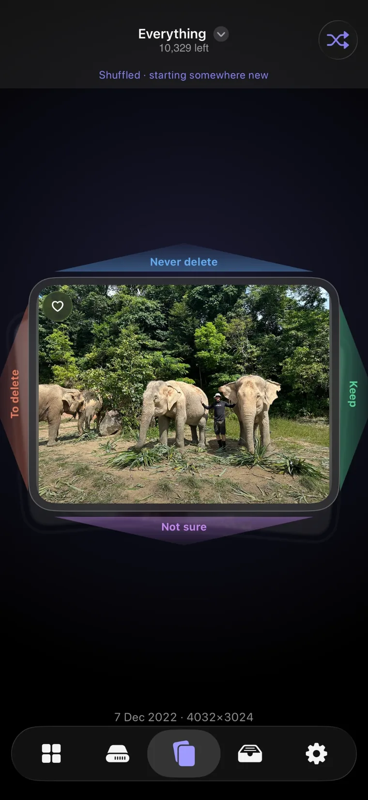 The Keep & Clear review screen: one photo shown as a card, with Keep, To delete, Never delete and Not sure labelled on the four edges, and 10,329 items left to review.